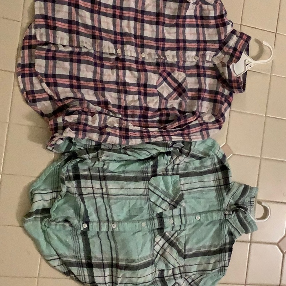 Two plaid collared button up long sleeve shirts